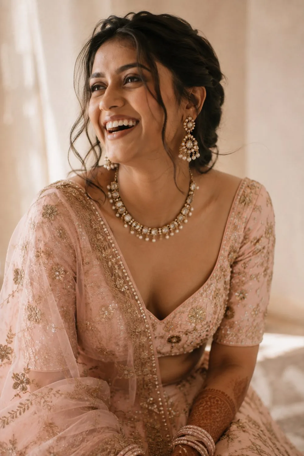 Bride in blush pink, laughing